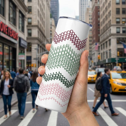 Preppy Stripes hidden message tumbler held up on a busy city street — burgundy, sage green, dark forest green, and blush pink chevron band pattern wraps the white 20oz skinny tumbler