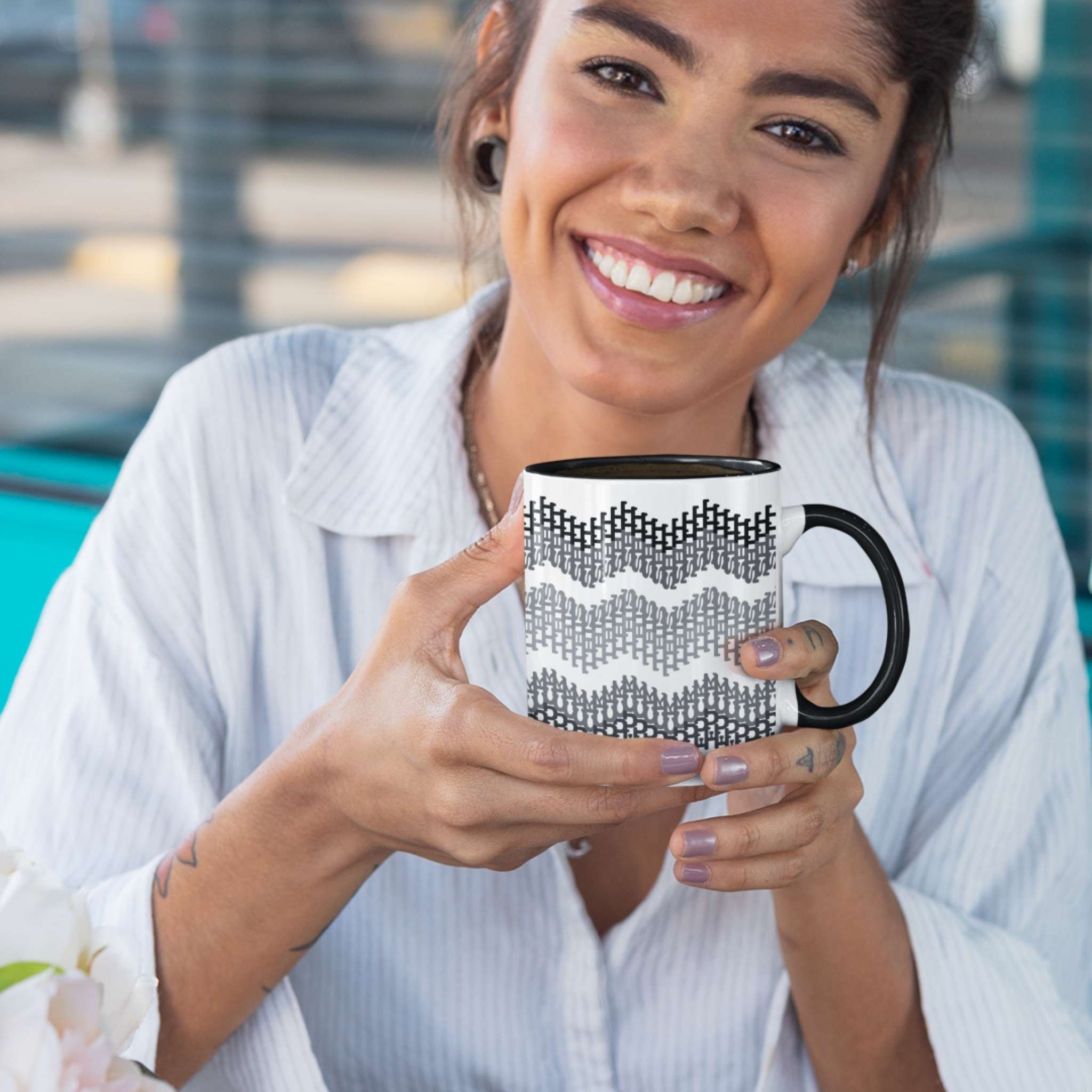 Woman smiling and holding hidden profanity accent mug with gray typographic chevron design, black handle visible