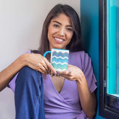 Woman holding ocean gradient hidden profanity accent mug with blue handle near window with teal frame