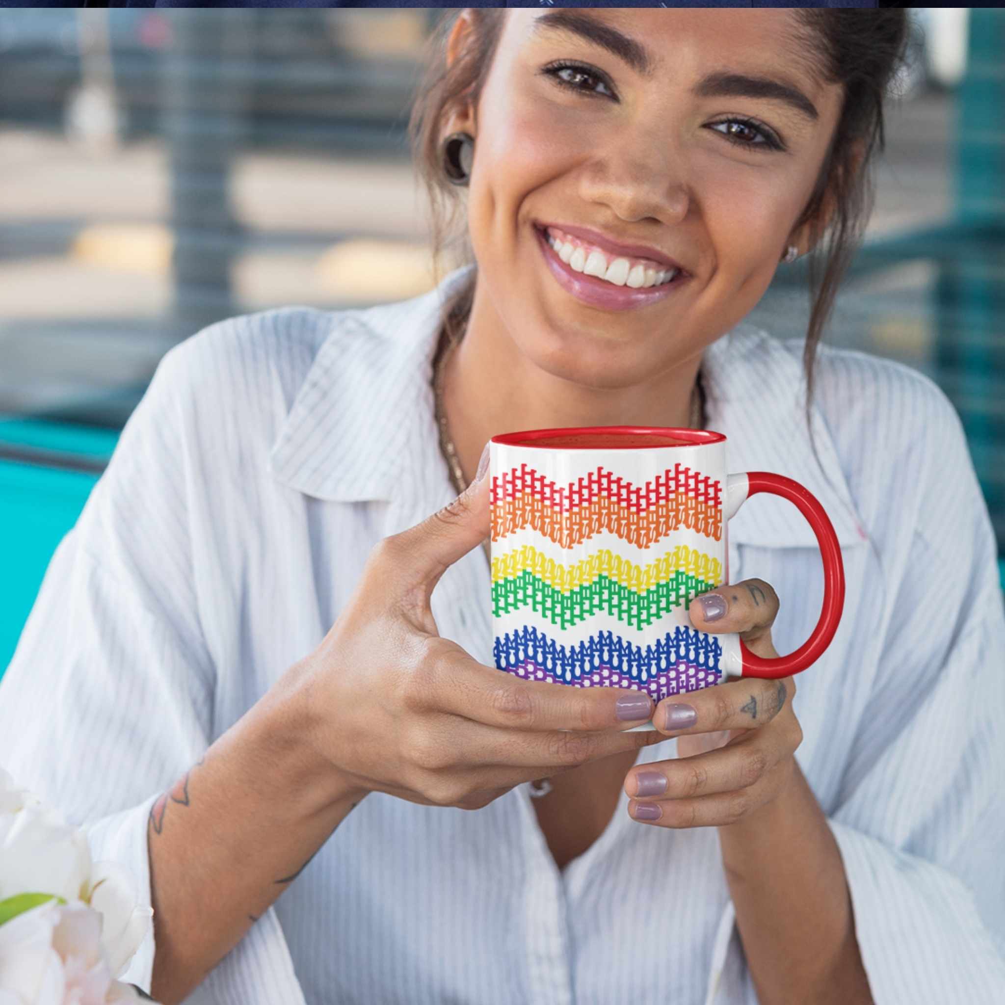 Woman smiling and holding rainbow hidden profanity accent mug with chevron typography pattern, outdoor setting