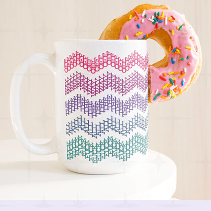 Bright stripes hidden profanity chevron mug in pink purple teal with a pink frosted donut balanced on the handle, retro styling