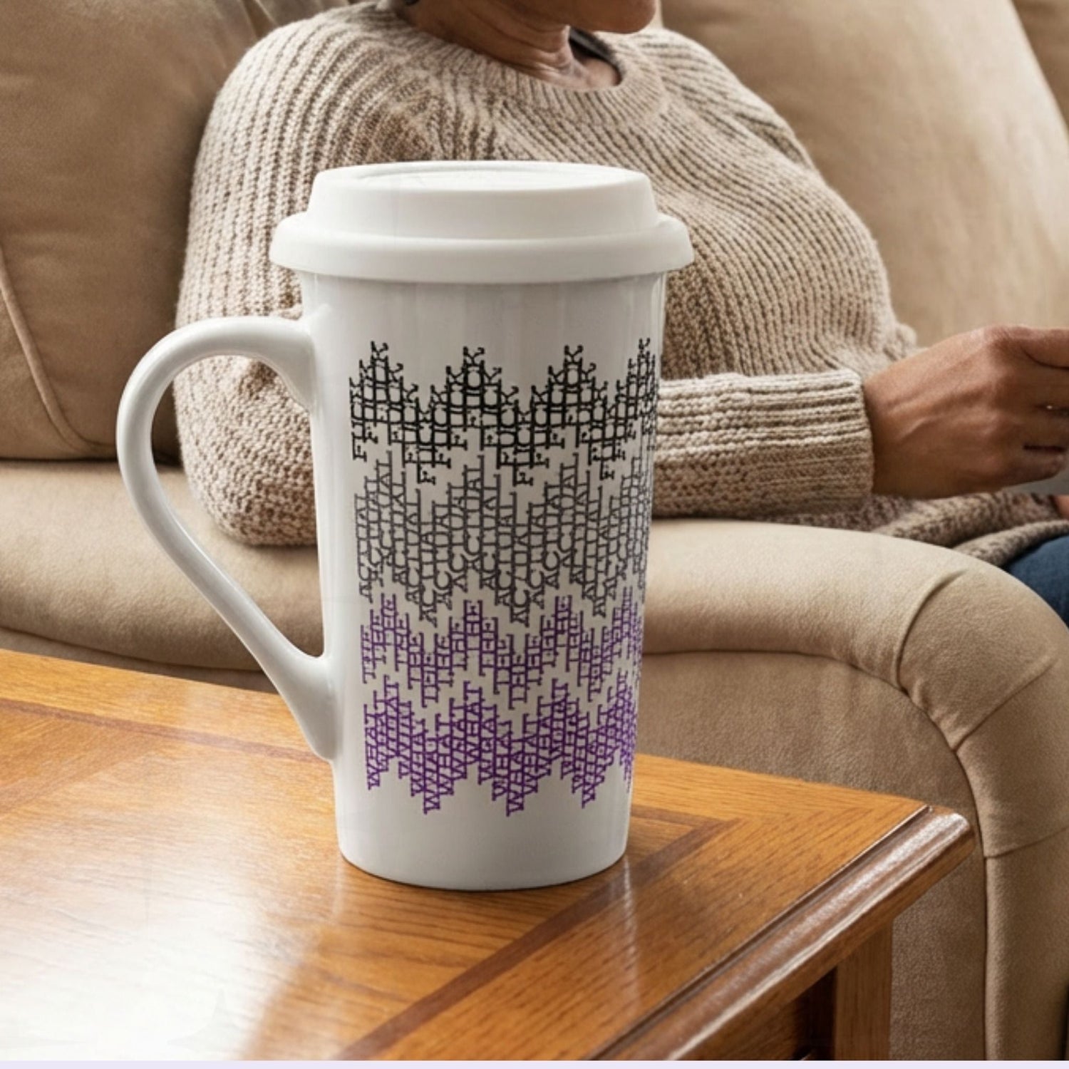 Purple ombre hidden profanity latte mug on side table next to person relaxing on couch, cozy home lifestyle setting