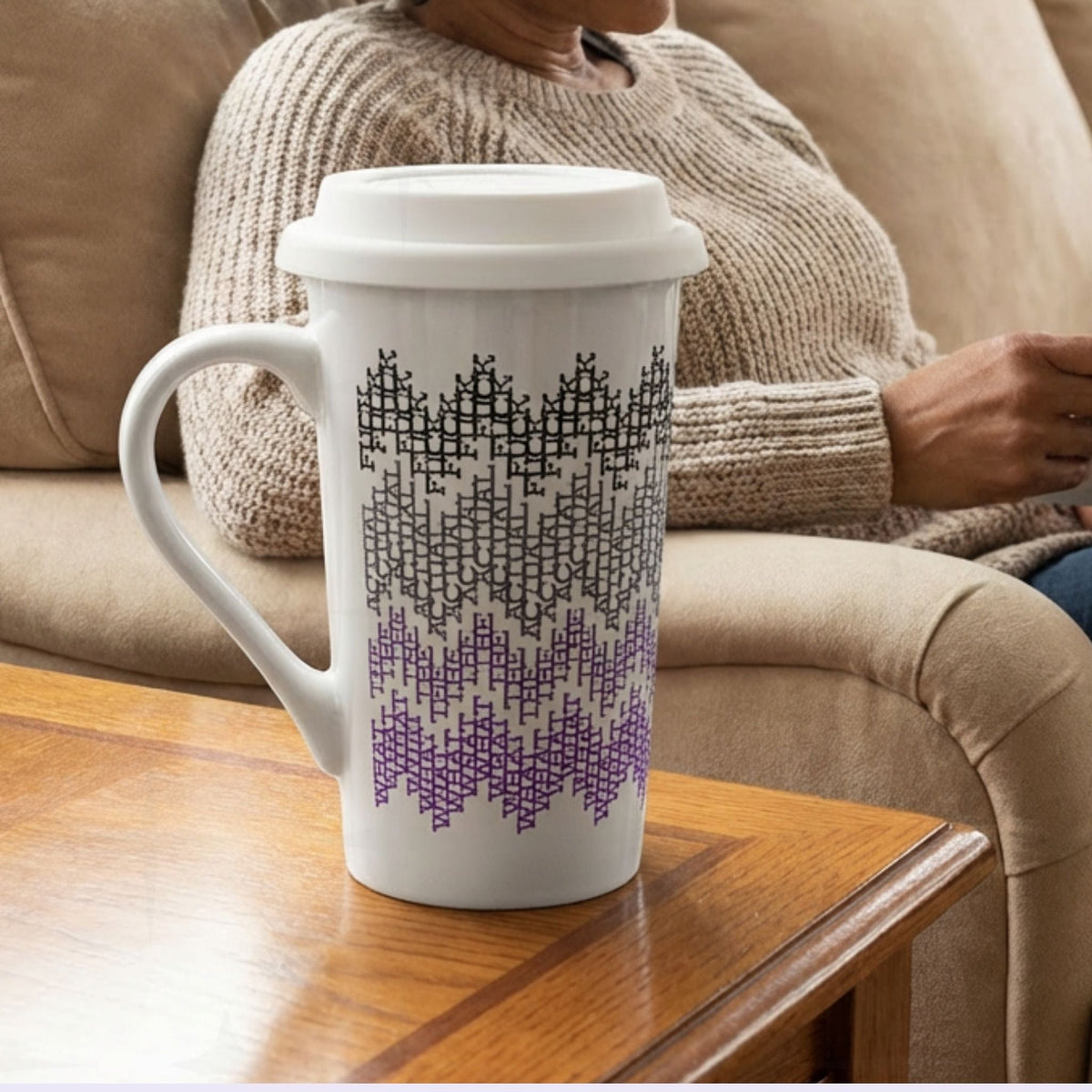 Purple ombre hidden profanity latte mug on side table next to person relaxing on couch, cozy home lifestyle setting