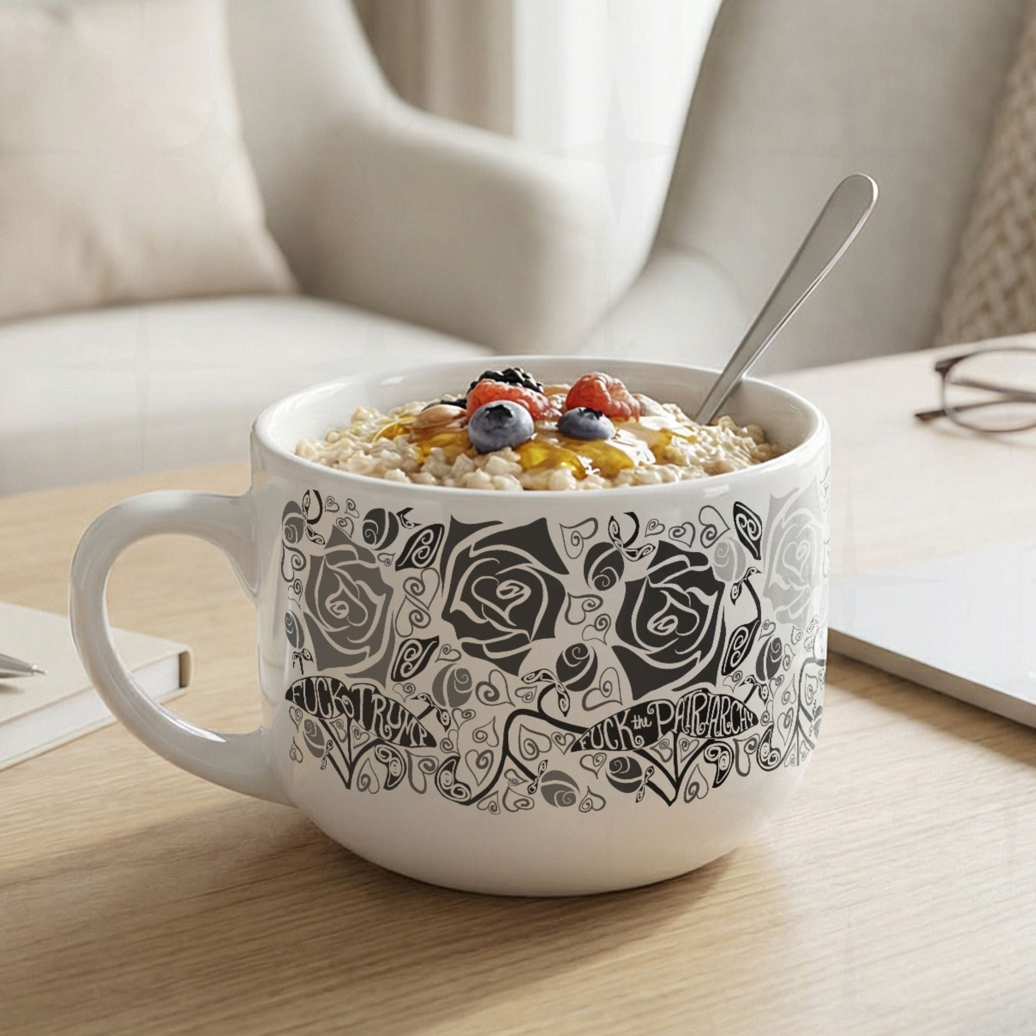 Hidden profanity 25oz latte mug filled with oatmeal and berries on wooden table, black and gray floral protest pattern with hand-lettered banners on white ceramic