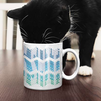 Black cat nosing into 11oz hidden profanity mug with ocean chevron pattern on dark wood table
