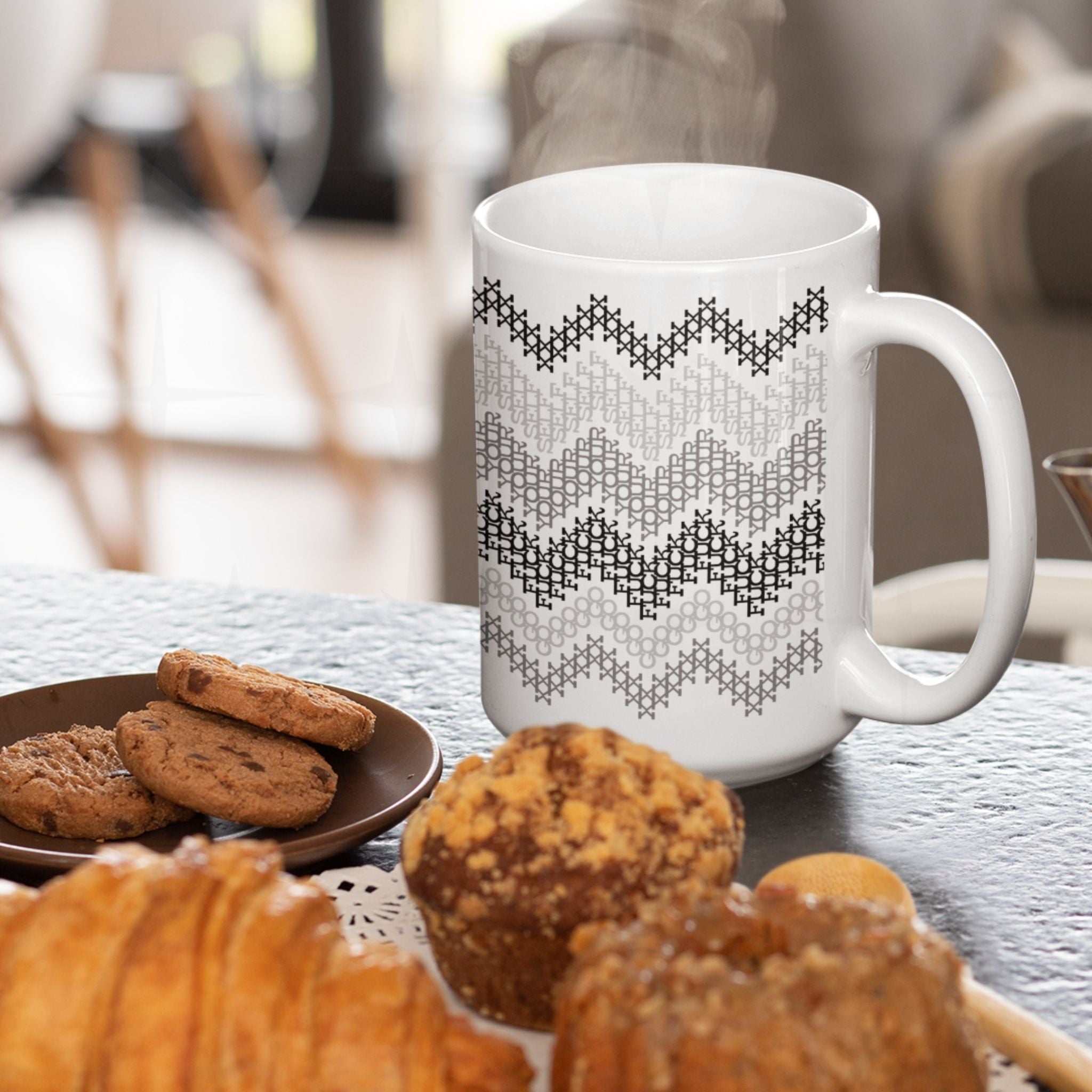 Hidden profanity ceramic mug gray stripe cross stitch pattern " go fuck your self" steaming on table surrounded by cookies and pastries