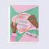 a greeting card of a person embroidering a happy holidays message