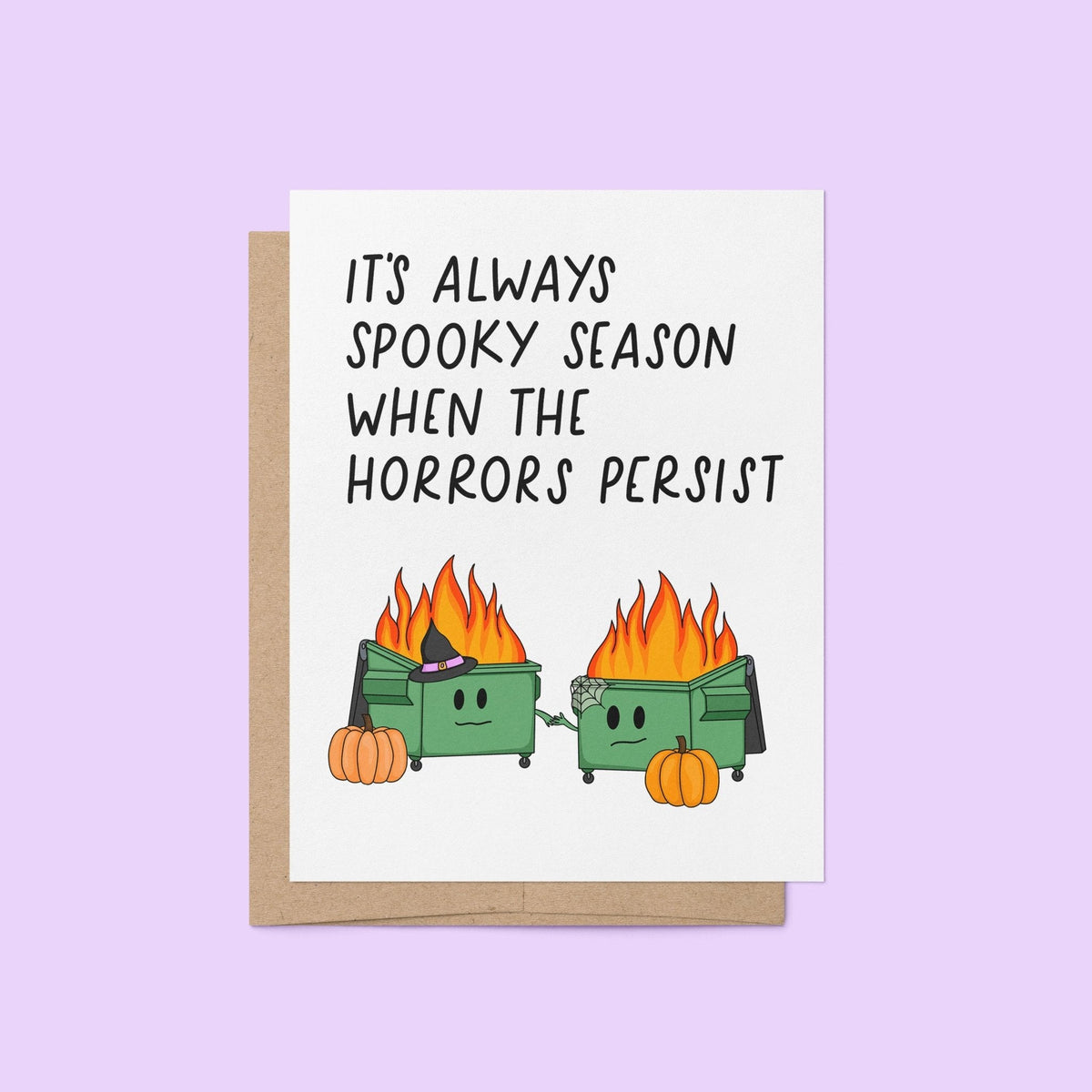 Horrors Persist Halloween card flat lay — funny spooky season dumpster fire card by indie artist MangoIllustrated
