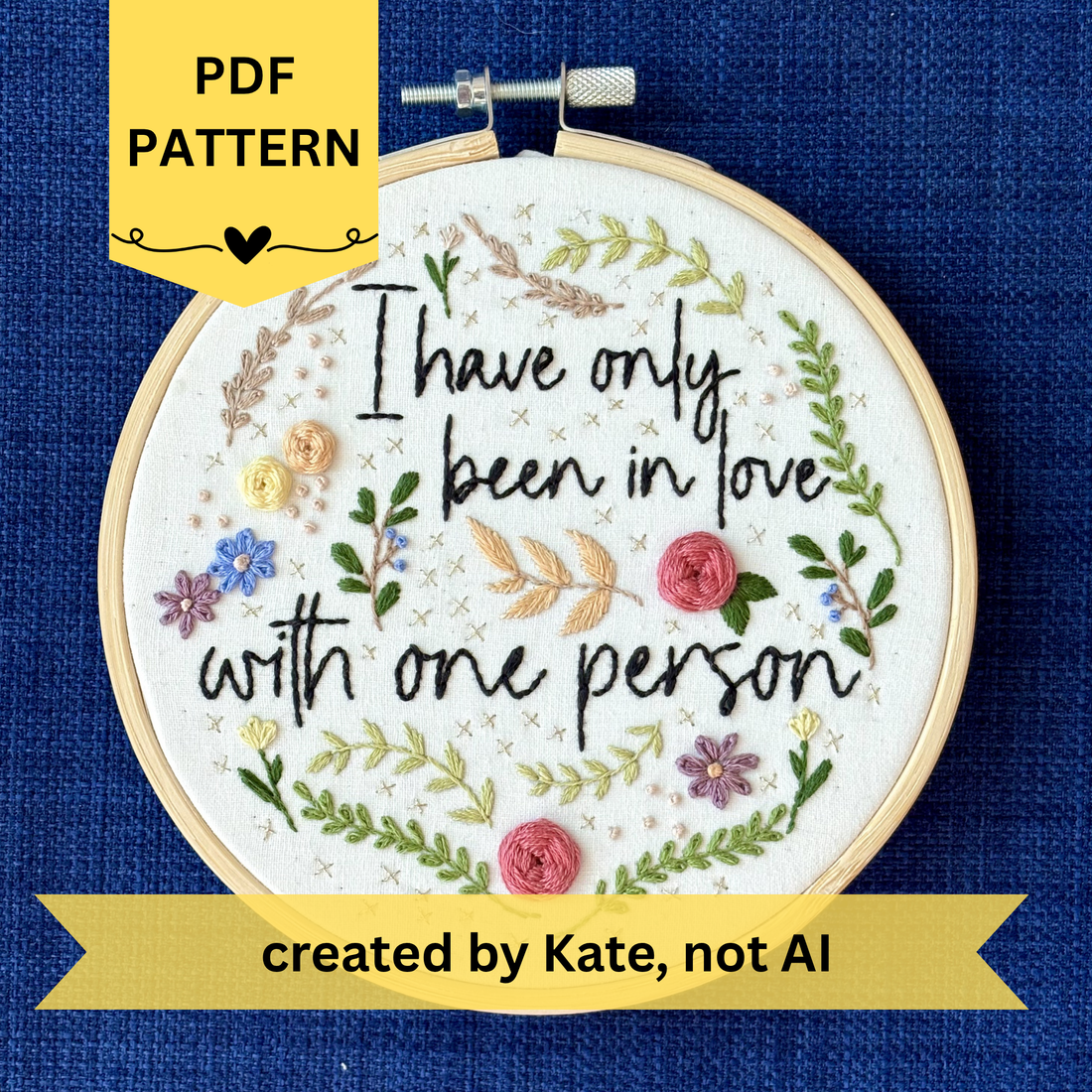 PDF pattern created by Kate, not AI. "I have only been in love with one person." Quote hand embroidered in handwriting font in black embroidery floss. Surrounding the text are vines and flowers and plants in shades of green, light browns, peach, pink, periwinkle blue, and dusky purple. Background is filled with pink dots and metallic gold Xs. Sewn on white cotton. Framed as wall art in a light wood embroidery hoop.