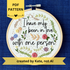 PDF pattern created by Kate, not AI. "I have only been in love with one person." Quote hand embroidered in handwriting font in black embroidery floss. Surrounding the text are vines and flowers and plants in shades of green, light browns, peach, pink, periwinkle blue, and dusky purple. Background is filled with pink dots and metallic gold Xs. Sewn on white cotton. Framed as wall art in a light wood embroidery hoop.