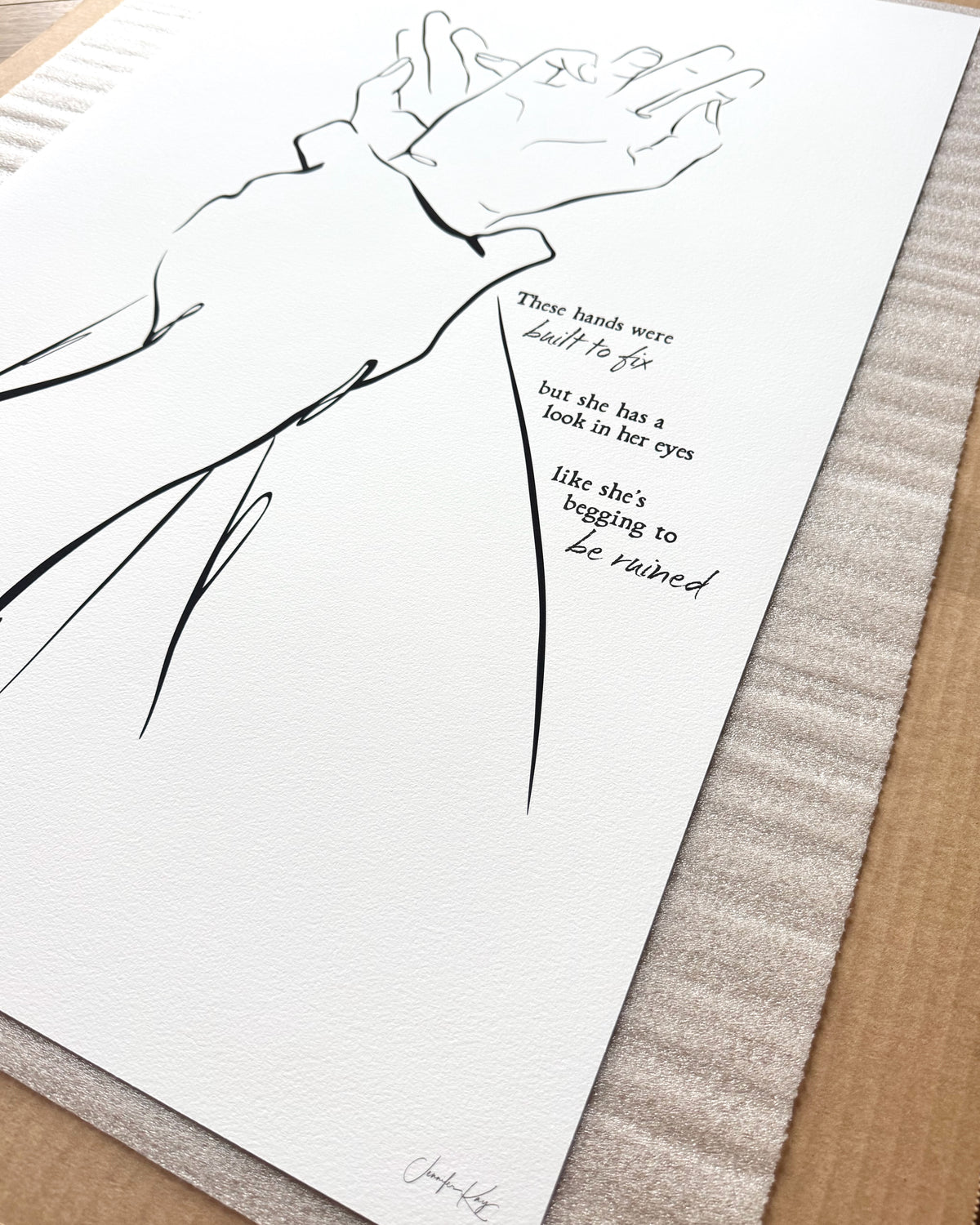 Black and white line art illustration "I Got You," of two hands clasped together. The text reads "These hands were built to fix but she has a look in her eyes like she&