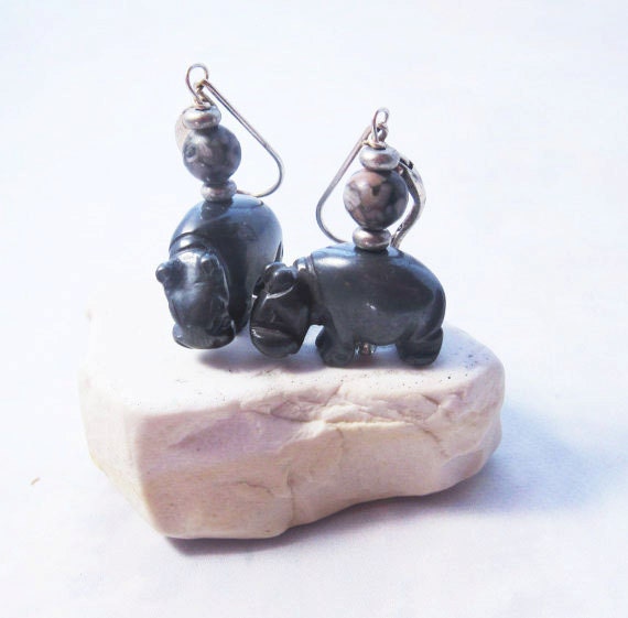 Close-up of hippo earrings, showcasing intricately designed hematite hippopotami jewelry.