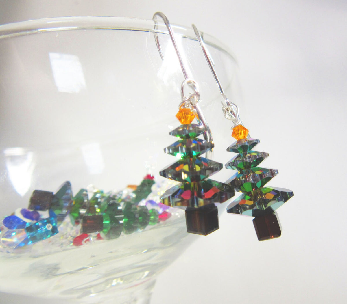 Deep Blue Shimmery Christmas Earrings crystal sparkle - Xmas jewelry - dangle earrings displayed on a festive background.