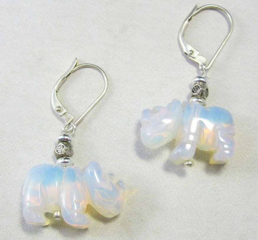 Close-up view of White Rhino Earrings showcasing the iridescent opalescent stone, ideal for wildlife lovers.
