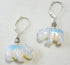 The Opalite White Rhino Earrings – Safari Wildlife Jewelry feature iridescent opalite rhinoceros charms and are displayed on a light gray background, said to inspire emotional balance.