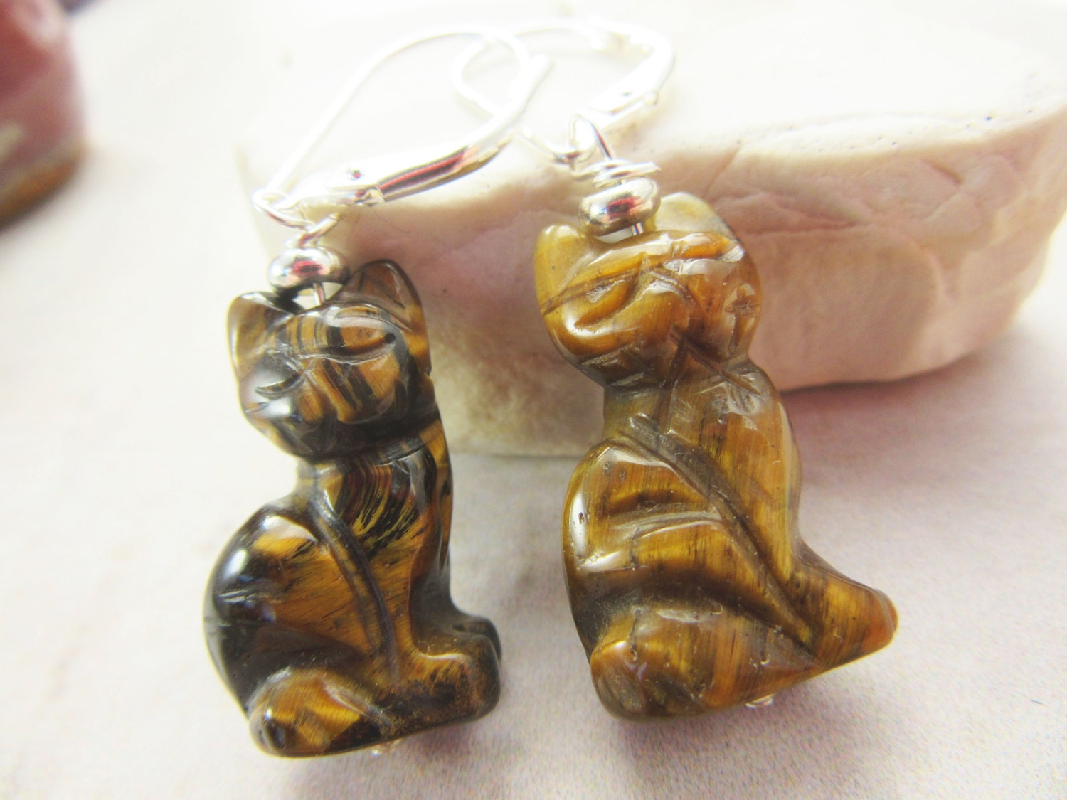 Close-up of Cat earrings carved tiger cat, highlighting the intricate etching details in the stones for cat lovers.