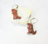 Tyrannosaurus rex earrings featuring intricate carvings and a rust goldstone finish, perfect for a paleontologist gift.
