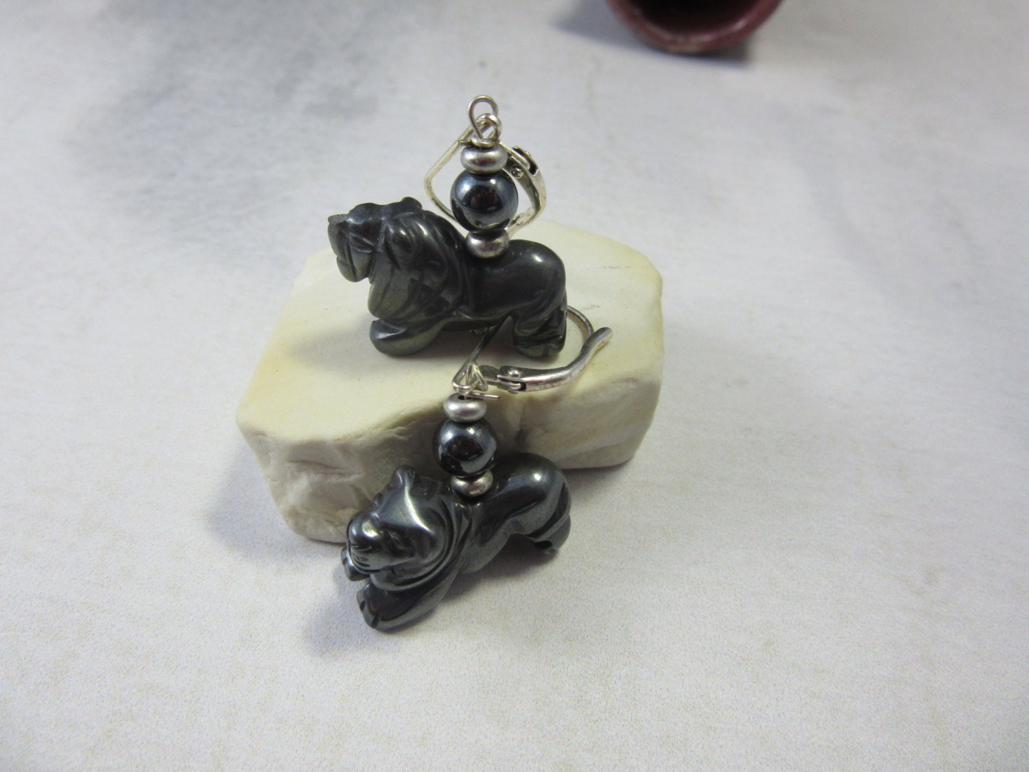Lion Earrings made of carved hematite, showcasing intricate lion designs, ideal for animal lovers and safari guide gifts.