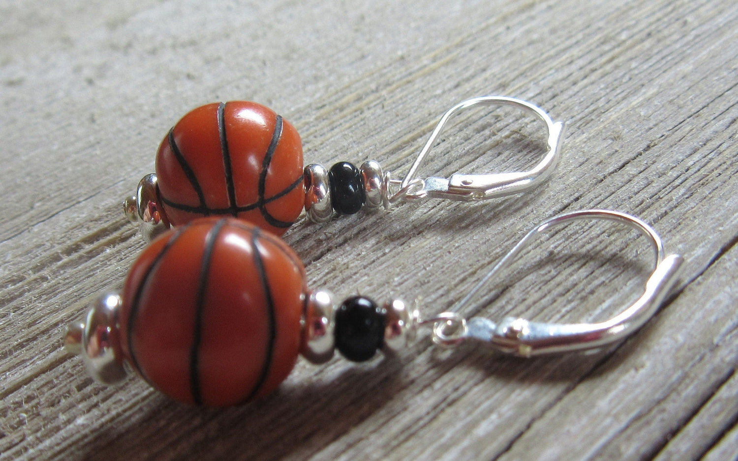 Basketball novelty earrings showcasing a basketball-themed design, perfect for sports girl enthusiasts and March Madness fans.