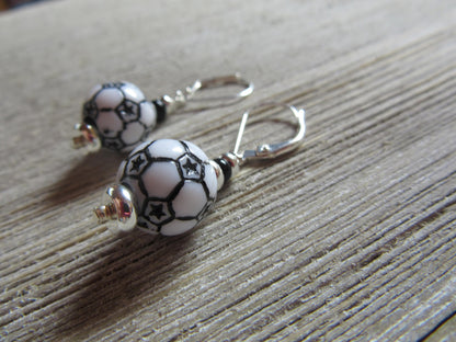 Flat lay of Soccer Ball Earrings showcasing their dangle design - Sports Theme Jewelry - Novelty Women Accessories by Enlivenadorn by Gwynstone.