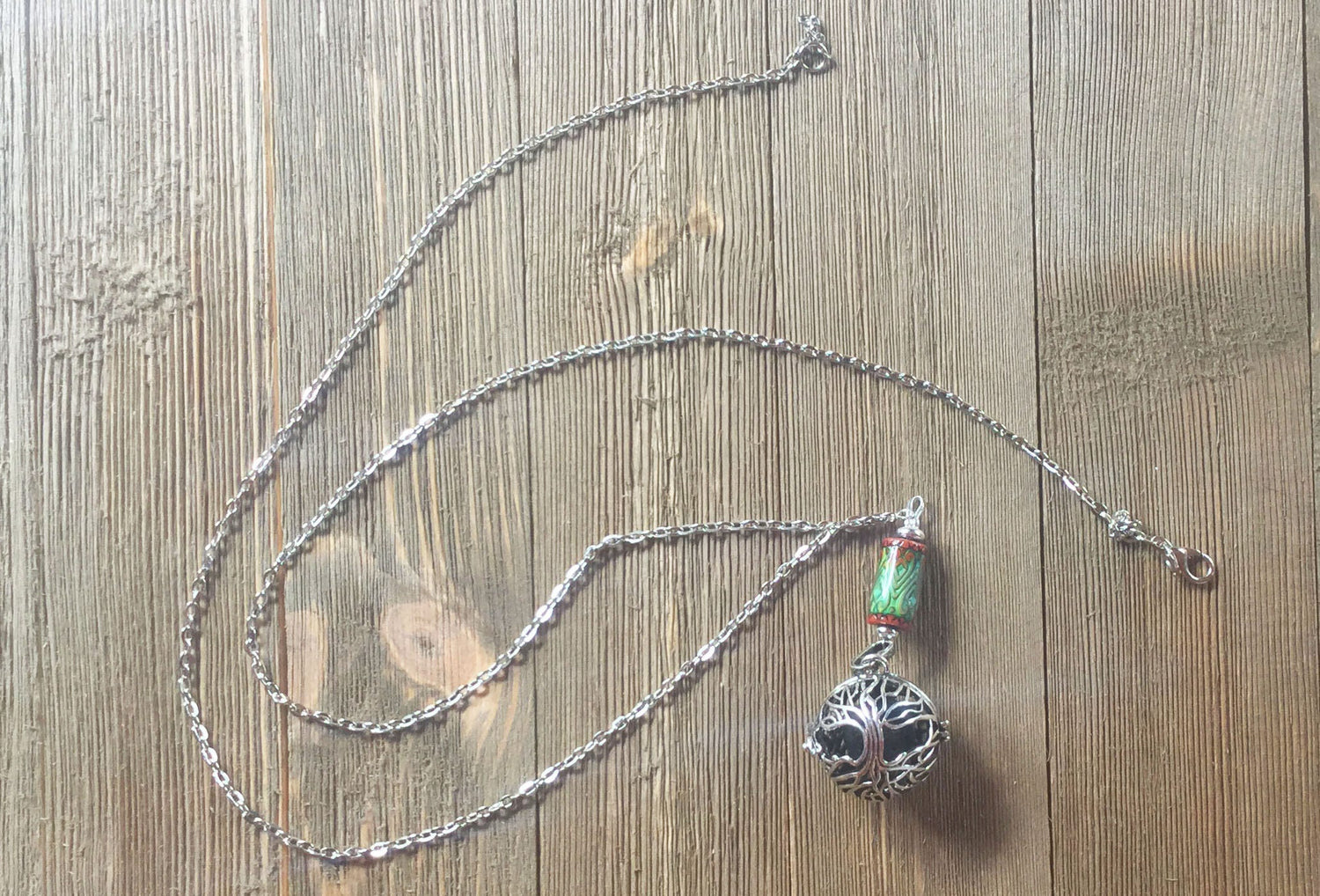 Close-up of COLOR CHANGING essential oil jewelry, showcasing intricate detail of the aromatherapy diffuser necklace, which transforms colors based on body temperature.