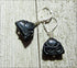 Handcrafted Black Onyx Buddha Earrings: Zen Jewelry Gift with carved Buddha charms and silver hooks, displayed on textured wood—ideal for a tranquil, stylish look.