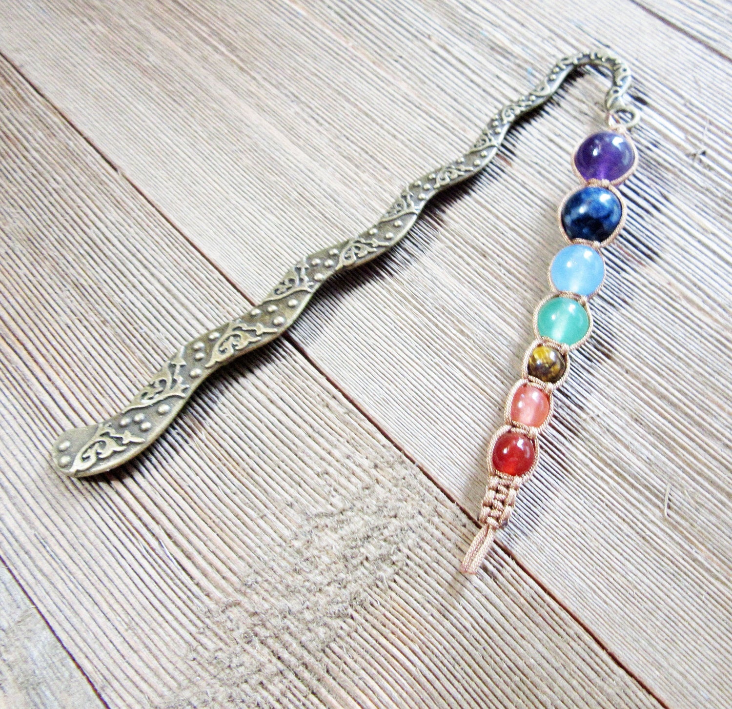 Chakra metal bookmark - intricate design showcasing 7 chakra beads, perfect gift for book lovers and spiritual readers.