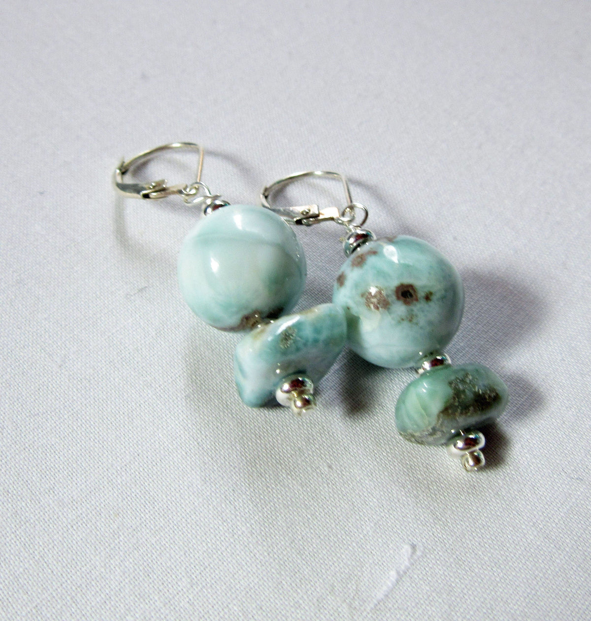 Close-up of Larimar Earrings showcasing stunning sky blue colors, handcrafted Dominican jewelry for the beach lover, ideal gift.