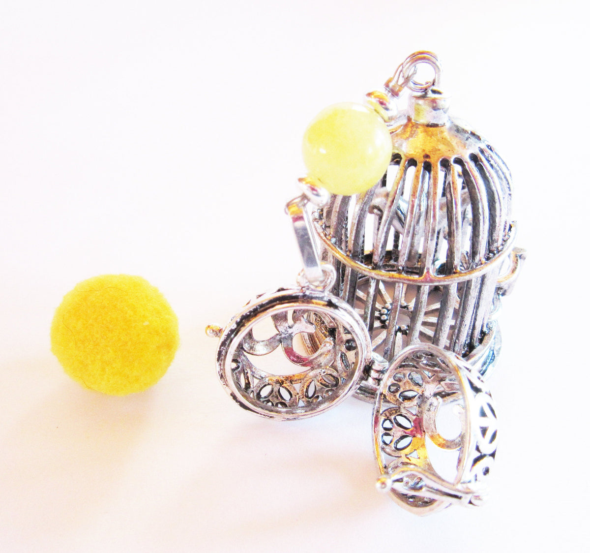 Bird Cage Essential Oil desk sitter featuring a silver metal bird and a cage; designed as an aromatherapy self-care gift with a zen aesthetic.