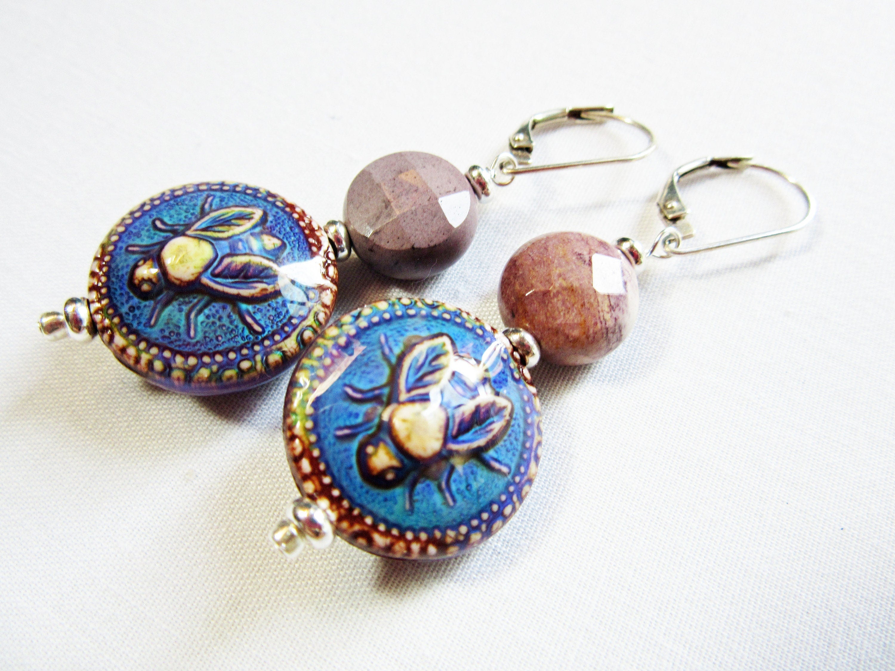 Close-up of Bee Earrings with Natural Stone Moukite Accent Bead, showcasing intricate design and vibrant color-changing features.