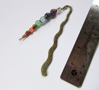Handcrafted chakra metal bookmark with 7 beads symbolizing root, sacral, solar plexus, heart, throat, third eye, and crown chakras, ideal for book lovers.