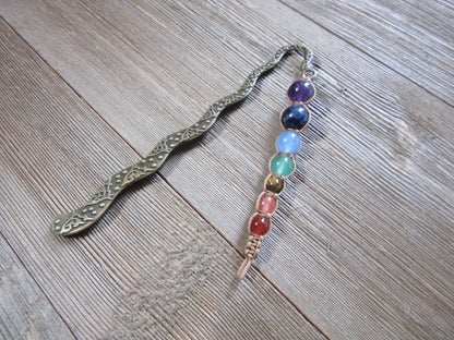 Chakra metal bookmark showcasing the 7 chakras, featuring intricately carved squiggle and chakra end, perfect book gift for spiritual readers.