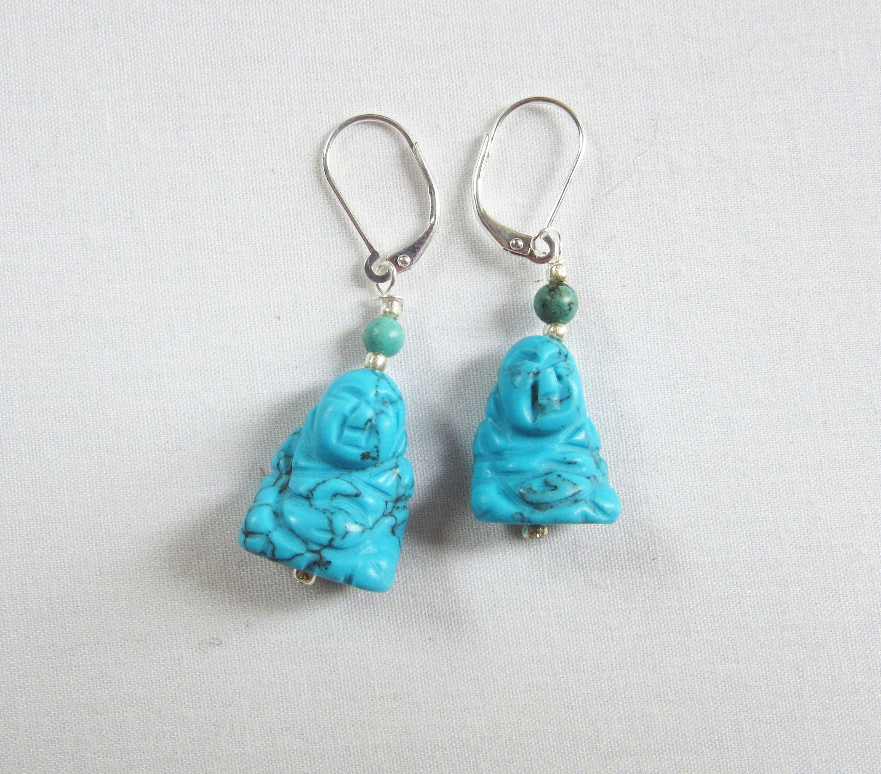 Lightly dangling Smiling Happy Man Zen Earrings with howlite and turquoise stones, ideal for adding zen style.