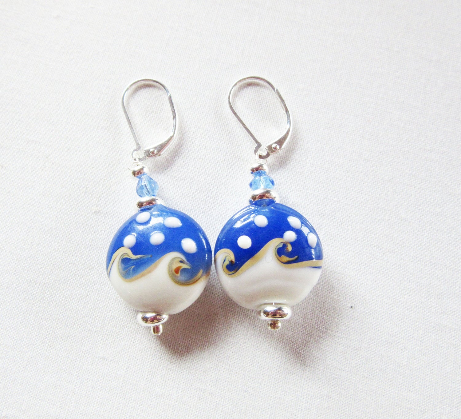 Ocean Wave Earrings say Hello - elegant gold earrings perfect for beach lovers, on sterling silver lever back, showcasing a unique ocean wave design.