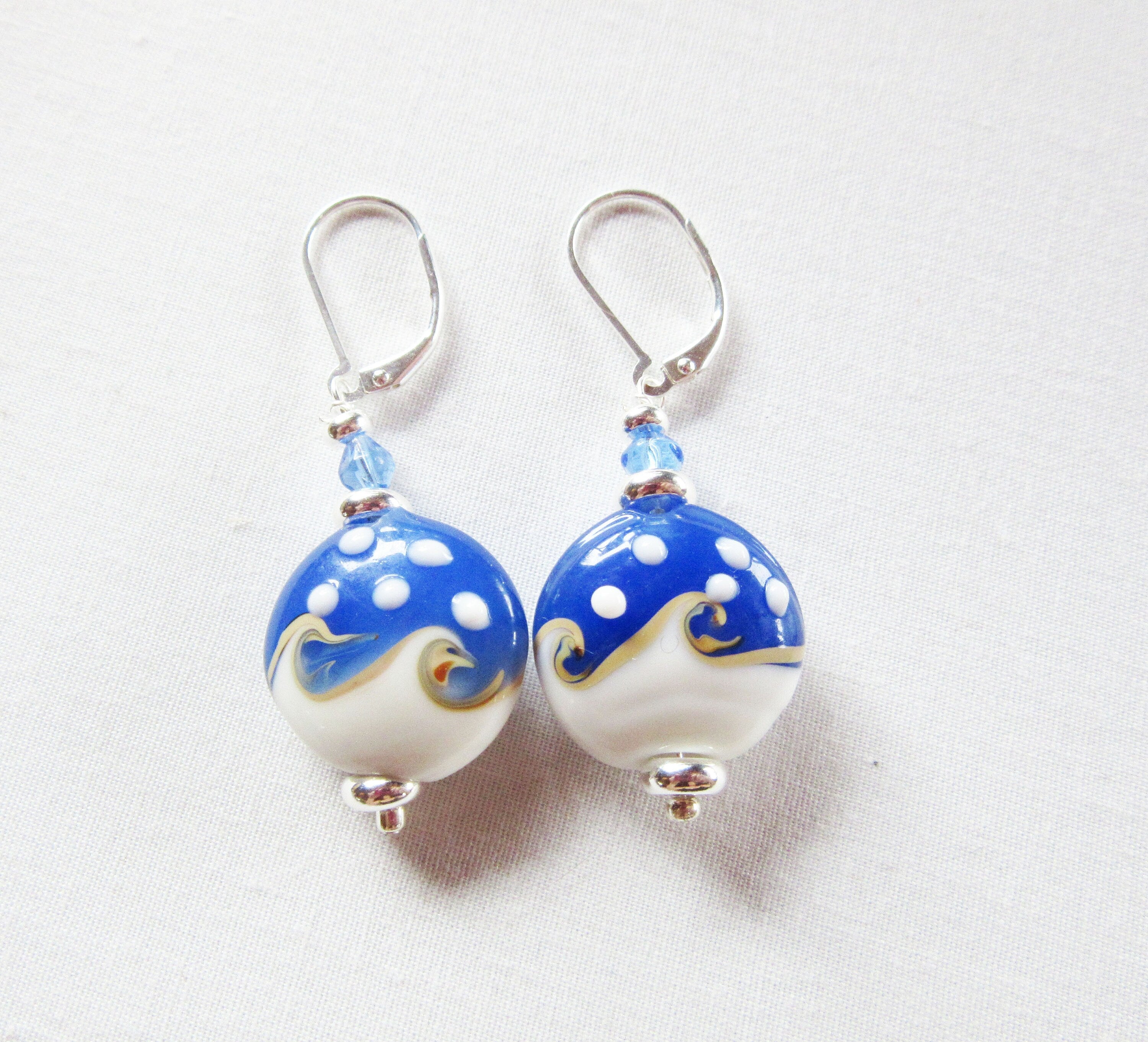 Ocean Wave Earrings say Hello - elegant gold earrings perfect for beach lovers, on sterling silver lever back, showcasing a unique ocean wave design.