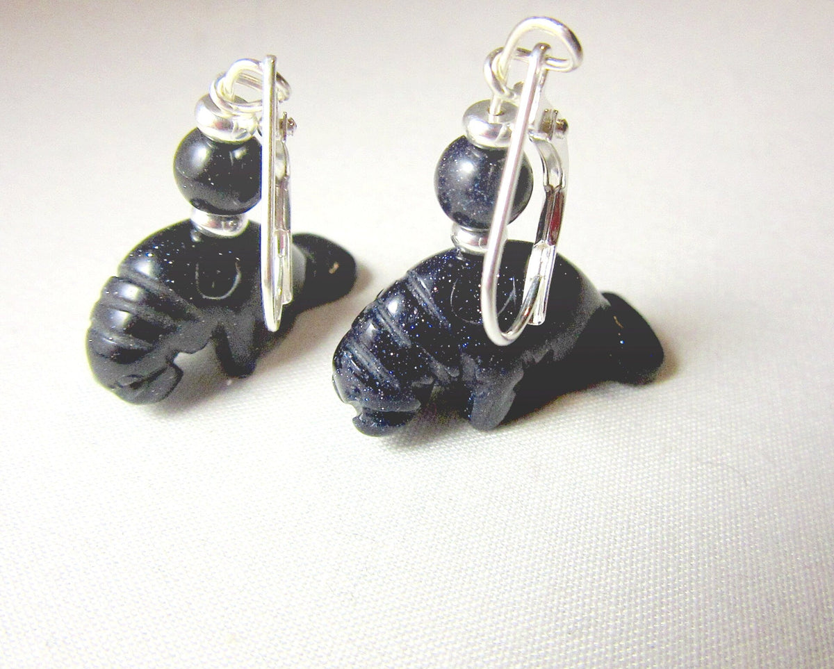 Artisan-made Manatee Earrings displayed elegantly, highlighting the unique carved animal design perfect for sea life enthusiasts.
