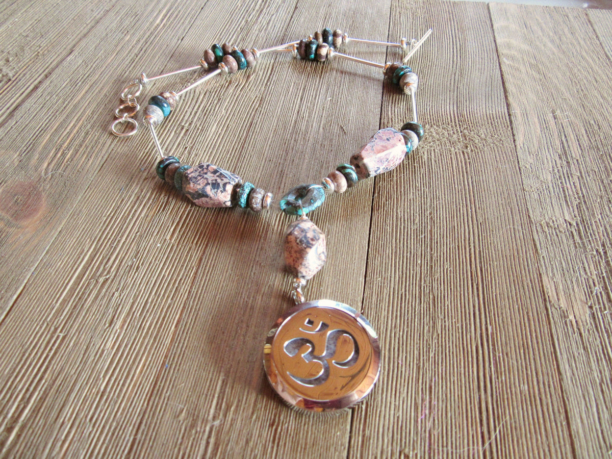 Rare stone essential oil diffuser necklace featuring rhodochrosite and turquoise with a Namaste symbol locket, designed for self-care.