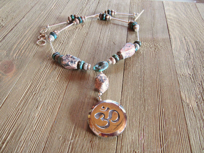 Rare stone essential oil diffuser necklace featuring rhodochrosite and turquoise with a Namaste symbol locket, designed for self-care.