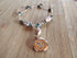 Rare stone essential oil diffuser necklace featuring rhodochrosite and turquoise with a Namaste symbol locket, designed for self-care.