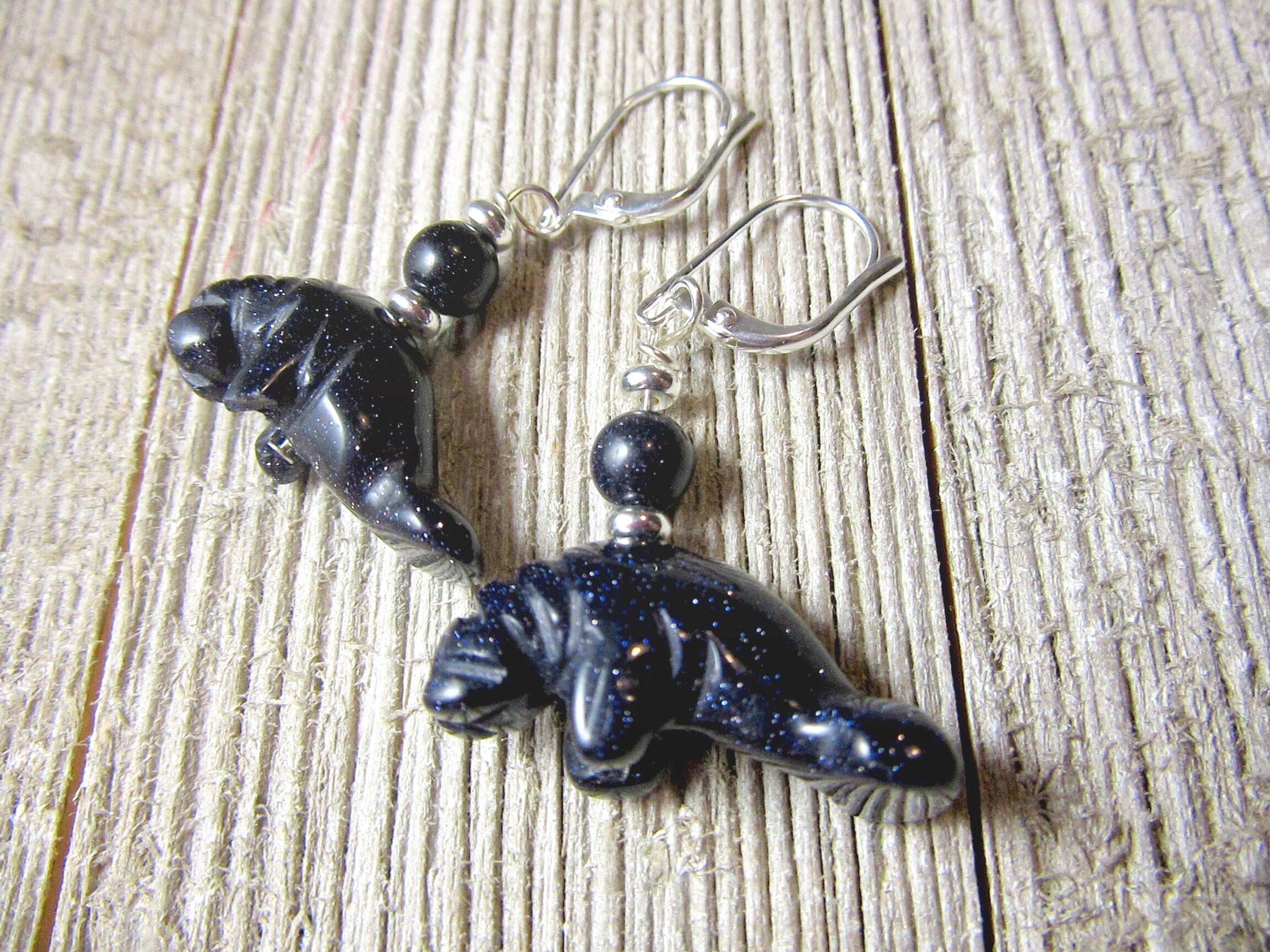 Manatee Earrings - artisan-made jewelry featuring sparkling carved animals in blue and orange goldstone, a unique gift for beach sea life lovers.