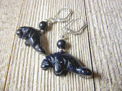 Manatee Earrings - artisan-made jewelry featuring sparkling carved animals in blue and orange goldstone, a unique gift for beach sea life lovers.