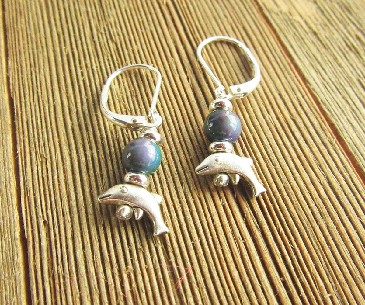 Close-up of Small Silver Animal theme Earrings, showcasing the dolphin design with mood bead topper - A unique color change jewelry piece for ocean enthusiasts.