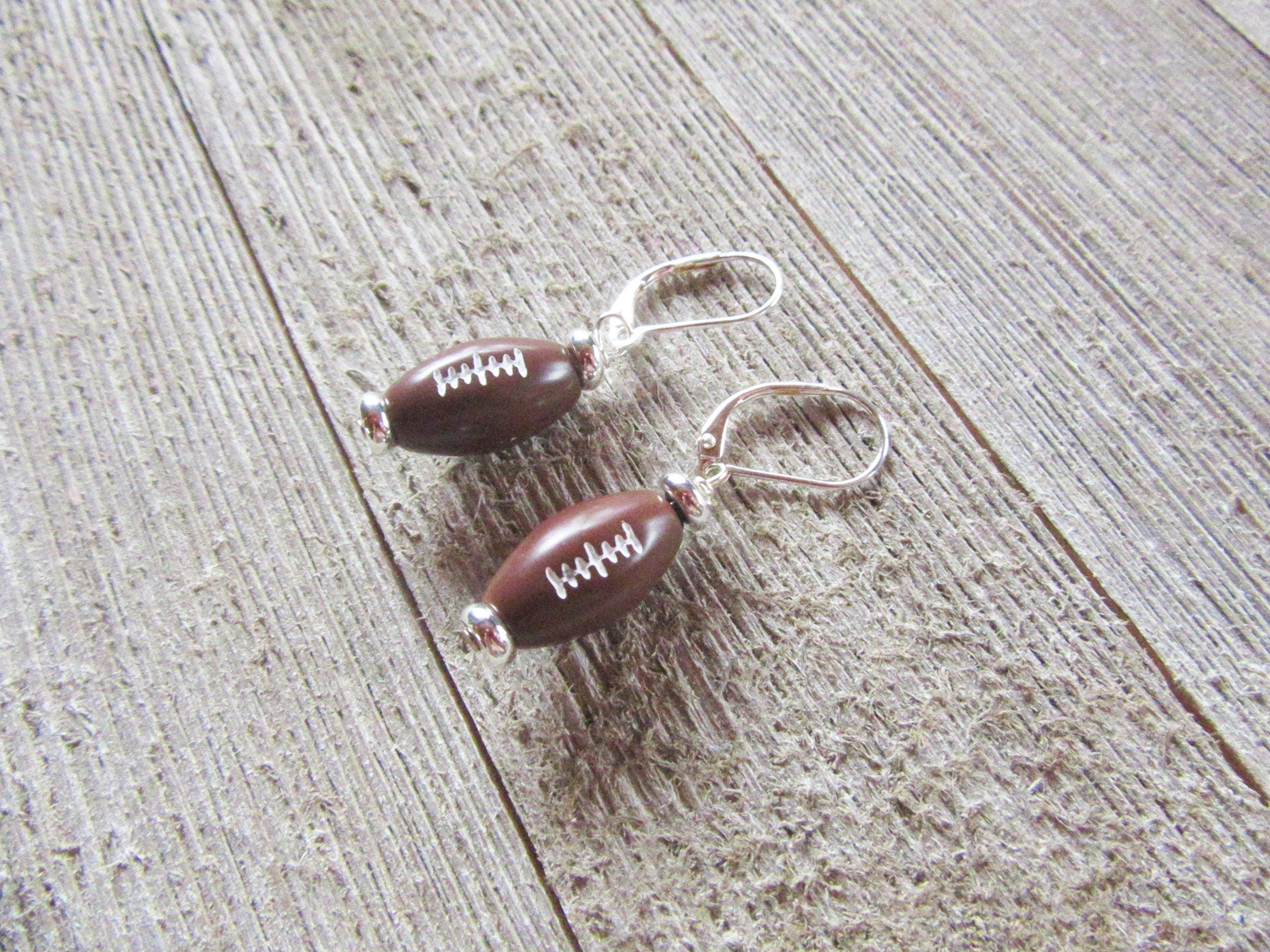 Football Novelty Earrings by Enlivenadorn - Handmade sterling silver earrings for sports enthusiasts.