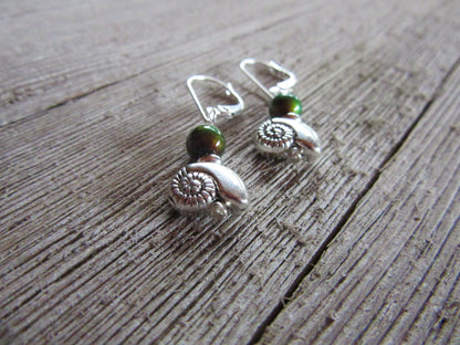 SEA SHELL EARRINGS - Display of elegant Silver Shell Earrings - Dangle style with vibrant color-changing beads, ideal for adding a touch of boho charm to any outfit.