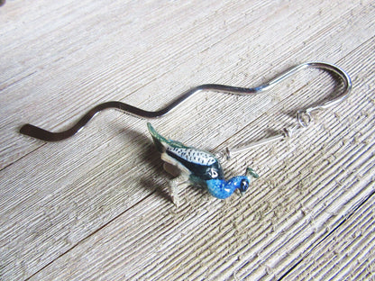 Detail view of Peacock Bookmark, showcasing intricate craftsmanship of the porcelain peacock figurine.