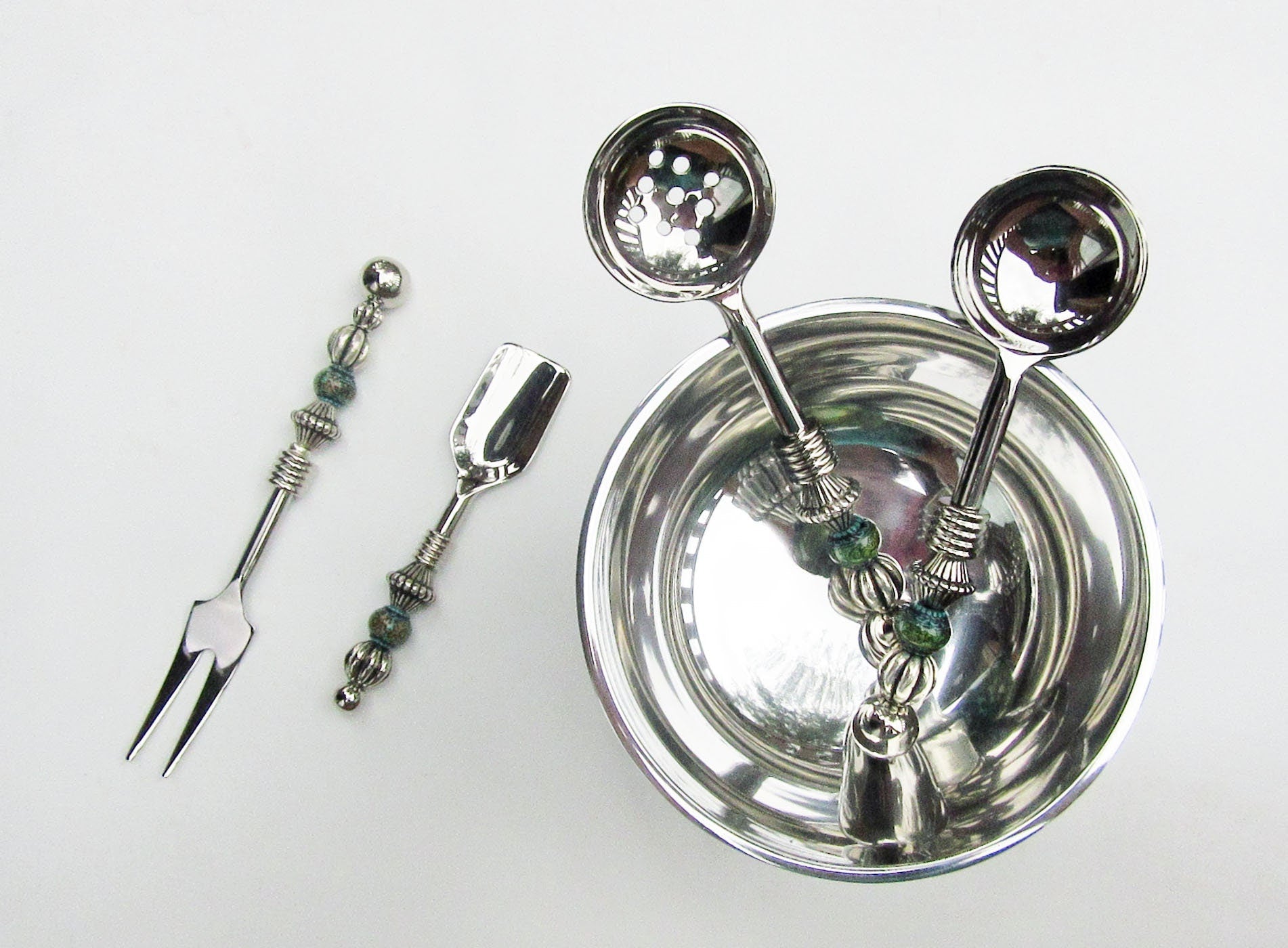 Party serving set featuring custom design stainless steel fork and slotted spoon, perfect for hosting.
