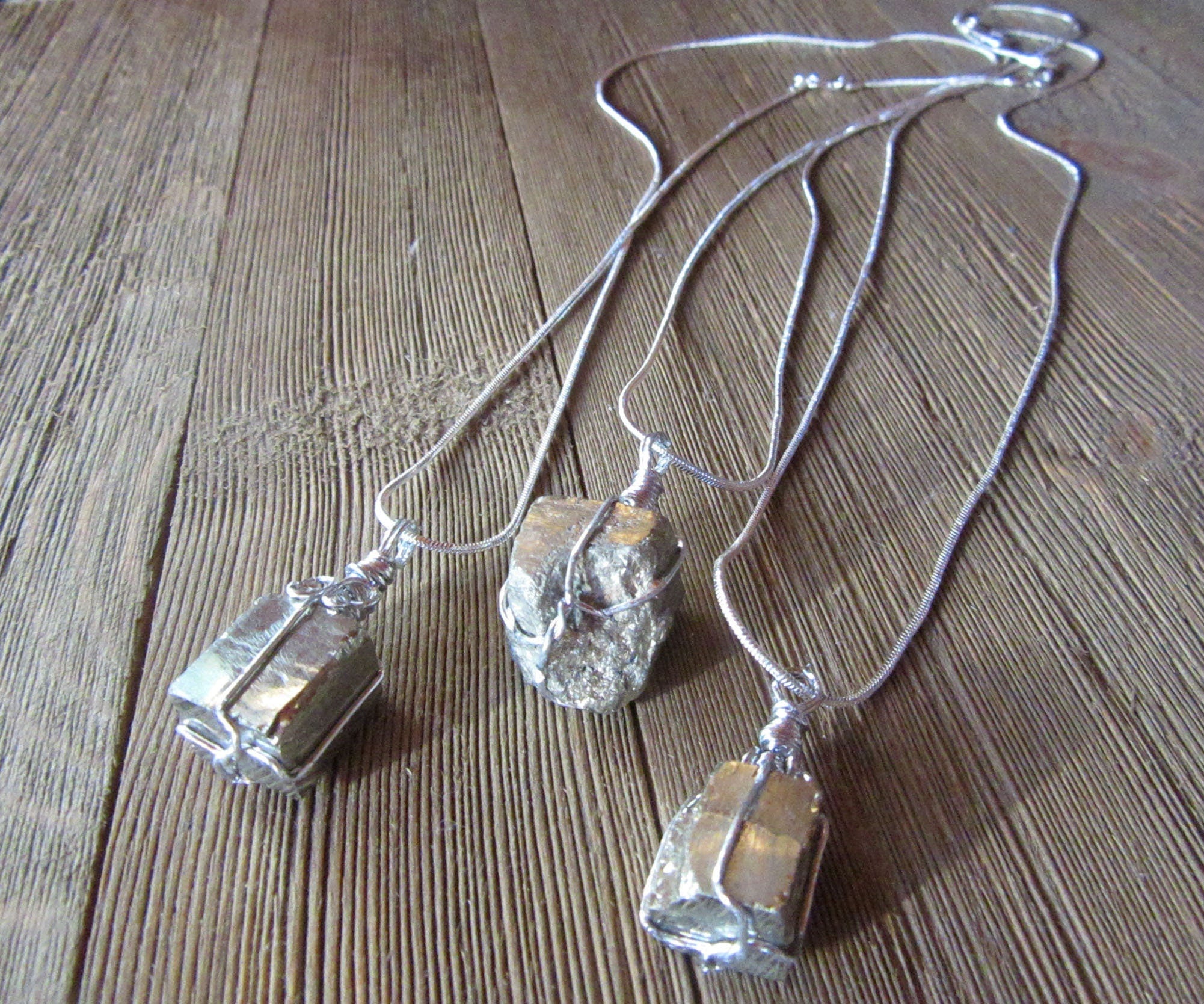 Close-up of the Pyrite Crystal Pendant - Chunky Gold Necklace showcasing the glimmering gold tones and unique wire wrapping, symbolizes protection and positive energy.