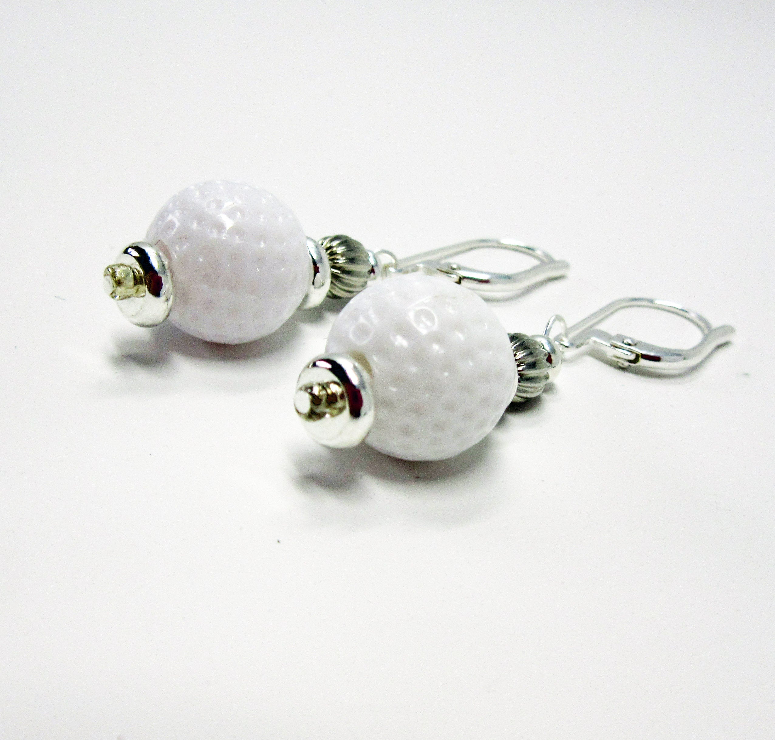 Golf Ball Lever Back Earrings: Novelty Jewelry Gift featuring white golf ball-textured beads with silver accents and secure hooks—an ideal accessory for golf jewelry enthusiasts.