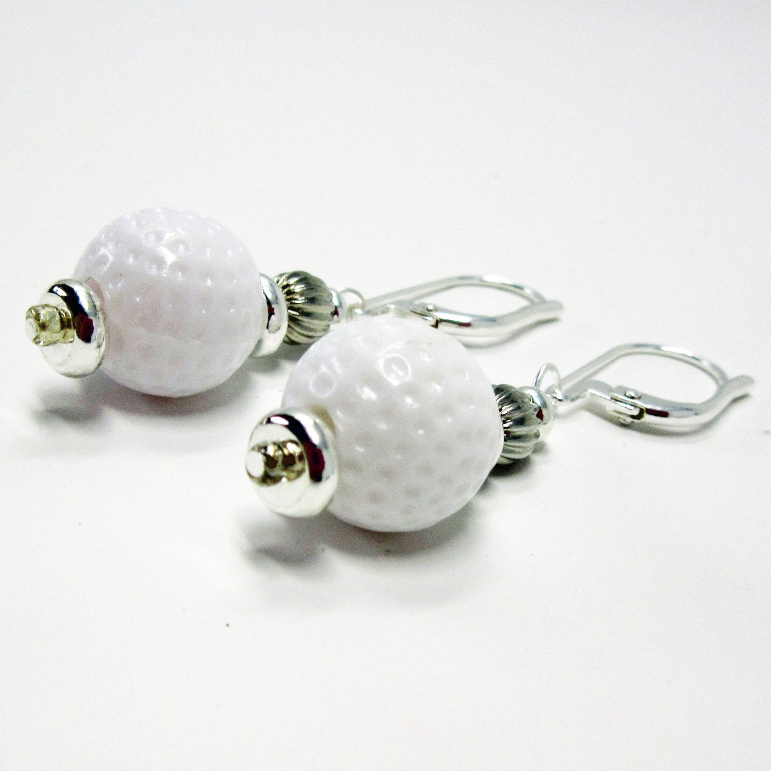 Golf Earrings a Gift for Woman Golfer worn by a person, perfect for any golf enthusiast.