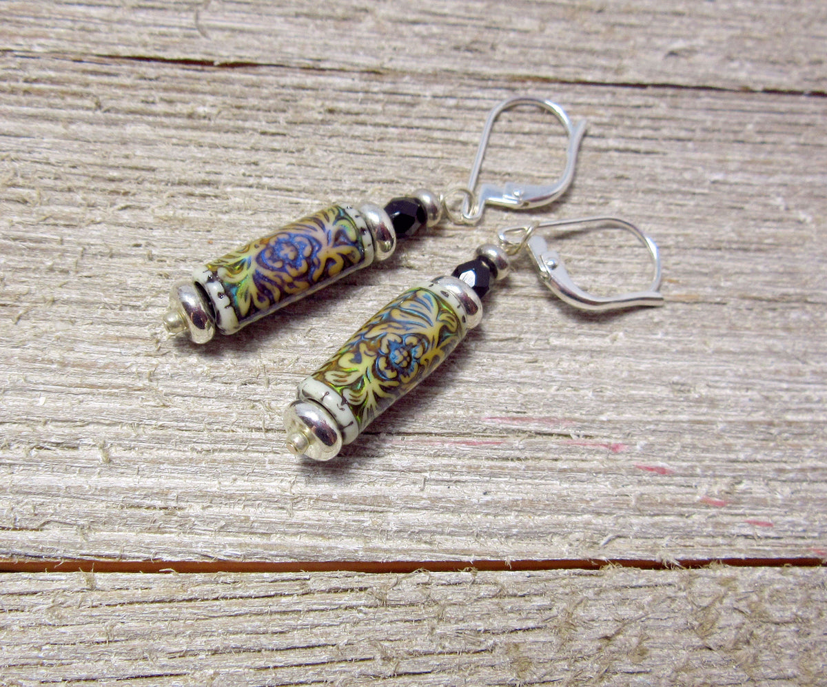 Diffuser Necklace displayed elegantly with essential oil around, representing a perfect aromatherapy locket gift for her with its unique floral pattern.